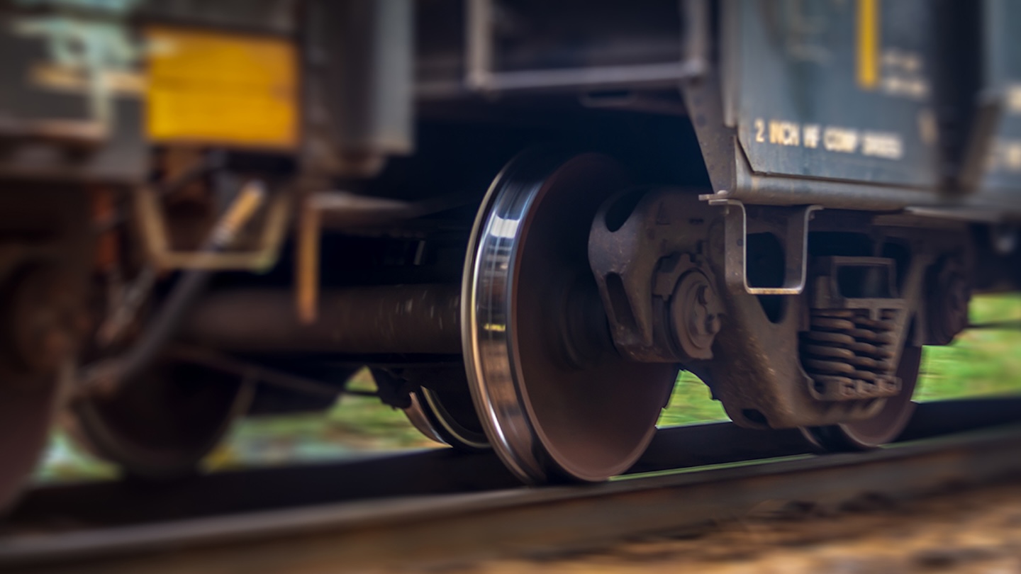 A close up view of a trains wheel in motion as it speeds past